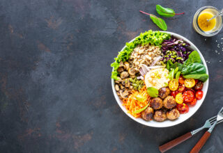Grilled chicken, rice, spicy chickpeas, avocado, cabbage, pepper buddha bowl on dark background, top view. Delicious balanced food concept