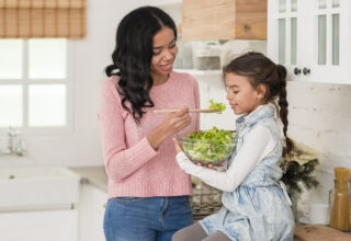 young-mom-feeding-her-daughter